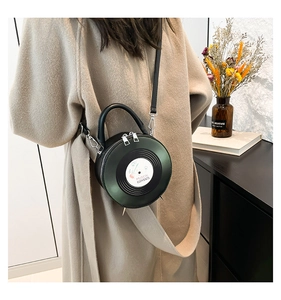 Retro vinyl record round crossbody bag worn by a model in a cozy indoor setting