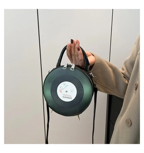 Detail of dark green vinyl record bag with musical elements and bottom metal studs