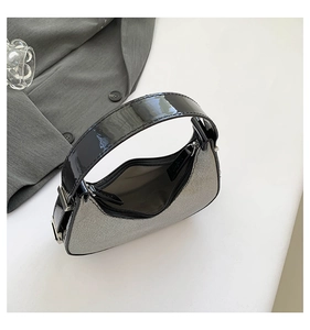 Top view of silver glitter crescent moon bag showing interior and black patent leather trim