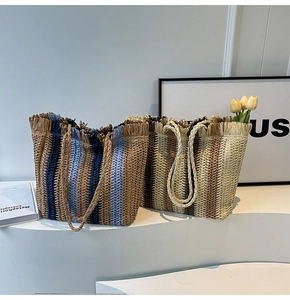 Detailed view of woven straw tote bags in blue and beige striped holiday patterns