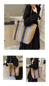 Close-up of woven straw tote bag featuring colorful vertical stripes and fringe details