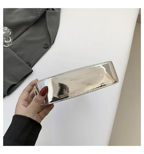 Detailed bottom view of silver mirror finish handbag with precise stitching and metallic texture