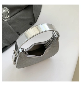Macro shot of sparkling silver moon bag featuring shiny metallic handle and top zipper