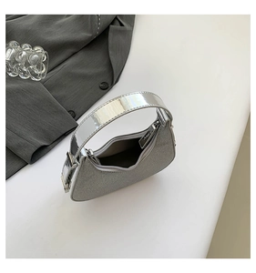 Detail view of silver hobo bag with sparkling finish and metallic handle for evening fashion