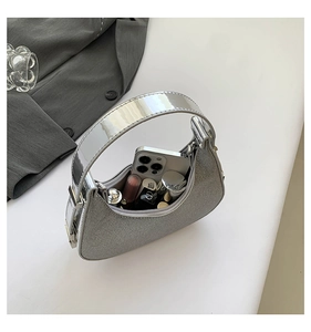 Silver crescent hobo bag interior showing storage space for phone and lipsticks