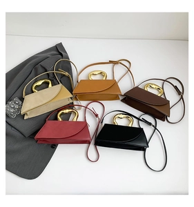Detail showing trapezoidal handbag colors with unique gold metal handles and straps