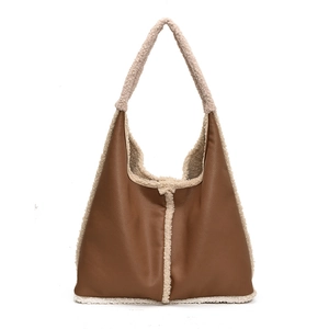Brown leather shoulder bag with white plush shearing trim and vintage hobo bucket design