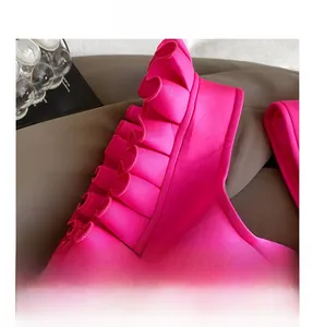 Detailed close-up of the fuchsia pleated strap with elegant ruffle design and texture