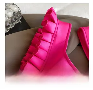 Detail of ruffled edges and pleats on hot pink oversized shoulder bag fabric texture