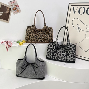 Plush leopard print and solid faux fur shoulder bags with chic bow and leather trim