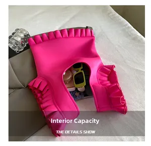 Internal capacity of vibrant rose red pleated bag showing sunglasses and cosmetics