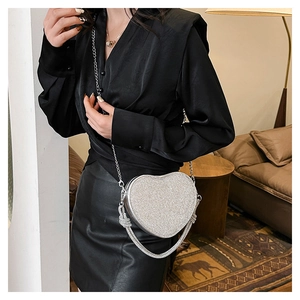 Elegant silver heart-shaped rhinestone handbag with metal chain and crystal knotted handle
