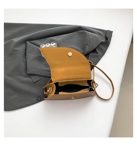 Internal view of brown saddle bag showing interior compartment and flap closure detail