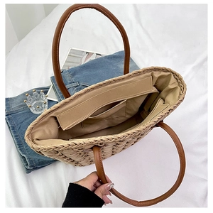 Top view of large straw tote bag showing spacious interior with zipper and fabric lining
