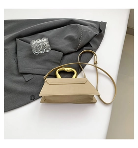 Detailed top view of a beige trapezoid handbag with a unique liquid metal handle