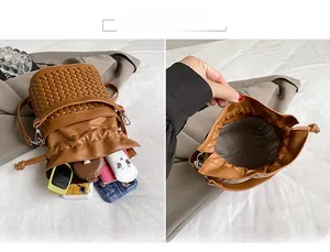 Detail view of woven leather bucket bag interior capacity and brown drawstring lining