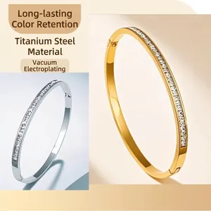 Titanium steel bangles with sparkling crystals in gold and silver finishes