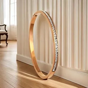 Elegant rose gold plated stainless steel bangle with pavé set white zircon stones