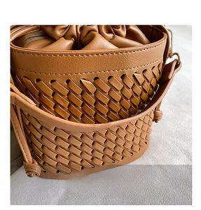Detailed macro shot of the premium dark brown woven texture on a stylish bucket bag