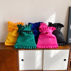 Chic ruffled shoulder bag in vibrant colors on a vintage cabinet for women's fashion