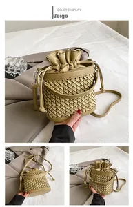 Detailed view of green woven bucket bag featuring drawstring closure and silver hardware