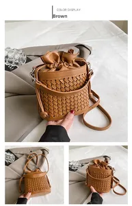 Detail of woven brown bucket bag with drawstring inner pouch and long shoulder strap