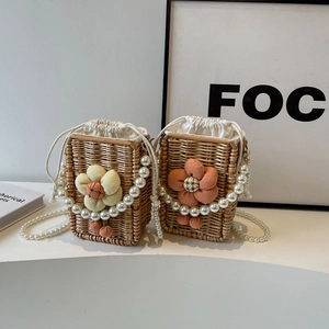 Mini straw bucket bags with fabric flowers and pearl handles for a vintage boho look