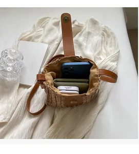 Interior view of straw crossbody bag showing storage space for phone and wallet