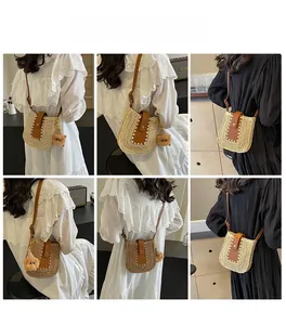 Detail showing straw woven crossbody bag with leather flap and cute bear pendant charm