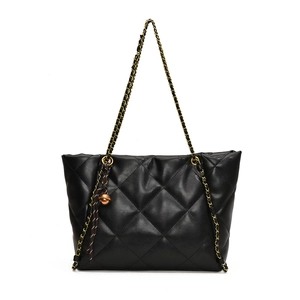 Classic black quilted tote bag with chain shoulder strap and decorative charms