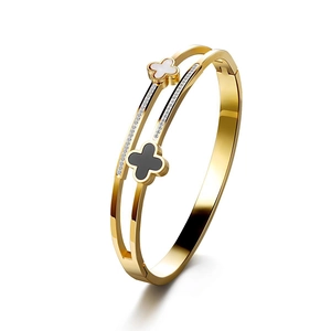 Double-layered gold titanium clover bangle with mother of pearl, onyx inlay, and pavé zircon