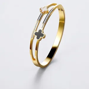 Elegant 18K gold plated titanium steel clover bangle with openwork and crystal accents