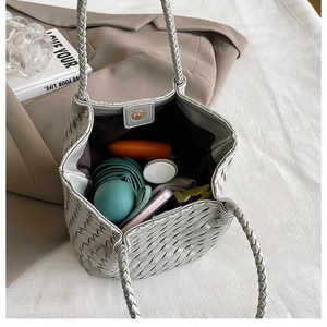 Macro view of woven silver-grey tote bag interior showing large capacity and magnetic closure