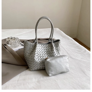 Detail of silver woven tote bag with matching zippered pouch and round braided handle