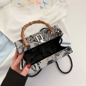 Elegant embroidered evening handbag with bamboo handle and beaded shoulder strap