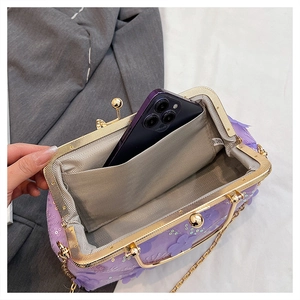 Detailed interior of purple sequin floral handbag showing smartphone storage capacity