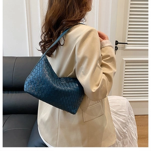 Detail of blue woven leather hobo shoulder bag showing intricate woven craftsmanship