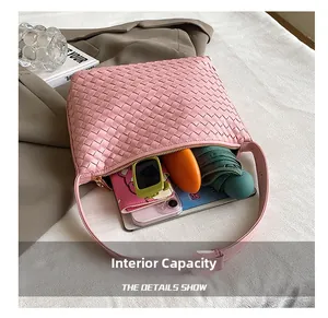 Close-up of pink woven hobo bag interior showing spacious capacity for wallet and umbrella