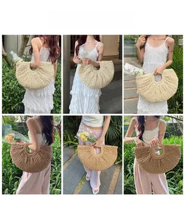 Outdoor lifestyle view of semi-circular straw woven handbags in cream and light brown