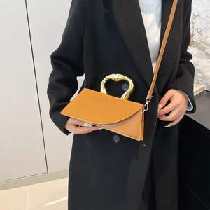 French style camel geometric handbag with a sculptural gold metal handle and crossbody strap