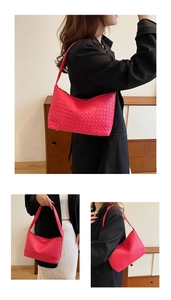 Detailed view of magenta woven hobo shoulder bag with intricate intrecciato leather pattern