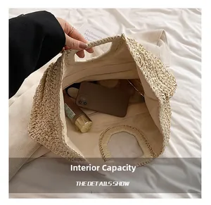 Detail view of woven straw tote with round handles and spacious zippered lining compartment