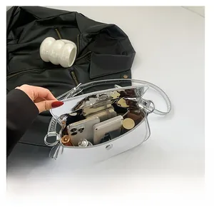 Top view of large capacity silver metallic bag interior holding phone and lipstick