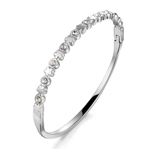 Detail of silver clover bangle with inset cubic zirconia and hinged clasp closure