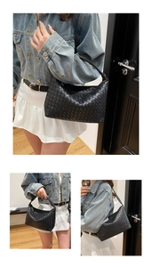 Detail of black woven leather hobo bag showing Intrecciato texture and seamless shoulder strap