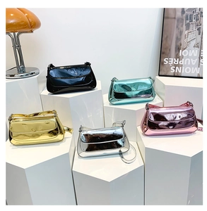 Detailed display of glossy patent leather baguette bags in various metallic color options