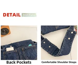 Detail of vintage denim shoulder bag showing back patch pockets and wide strap with rivets