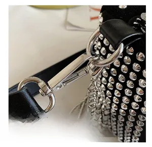 Close-up of premium silver metal hooks and chain on black rhinestone studded shoulder bag