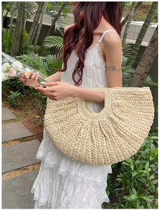 Detailed macro view of the cream white woven straw tote with a semi-circular fan shape