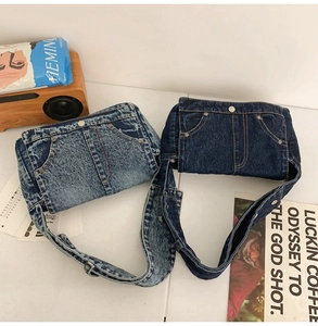 Detail of vintage denim crossbody bags showing washed blue fabric and metal rivet accents